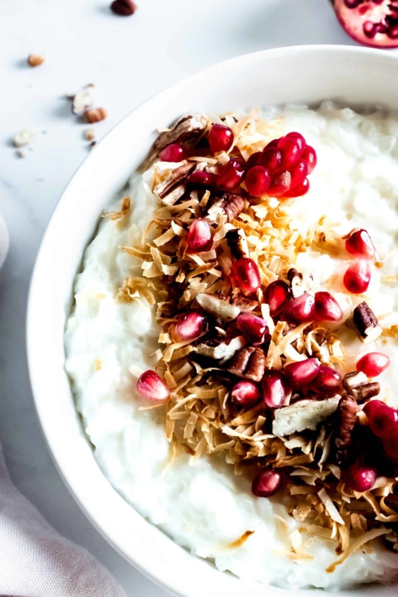 close up of pomegranate topping on rice porridge