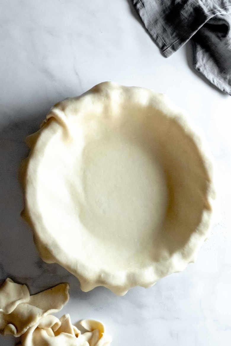 pie crust trimmed over pan