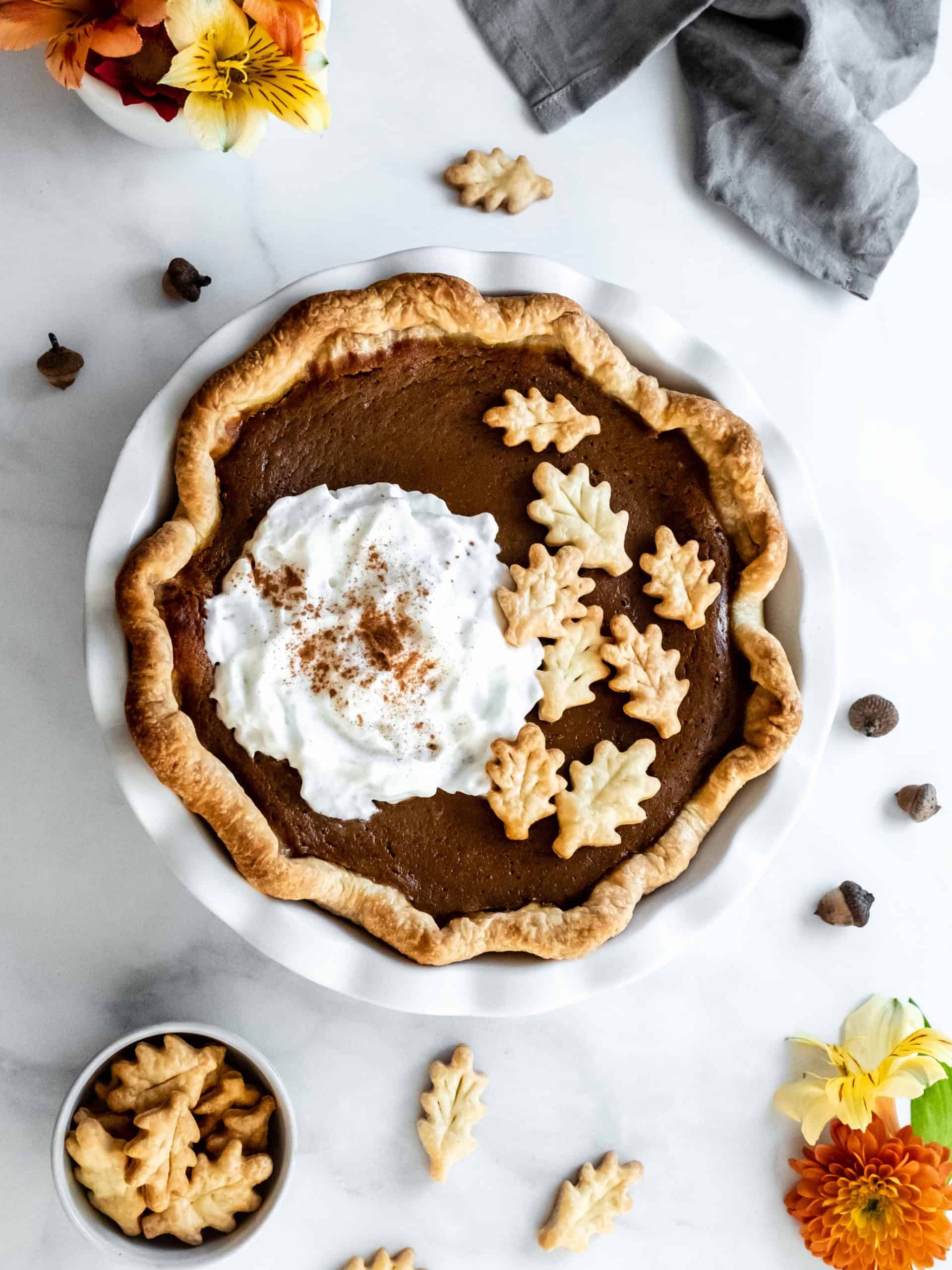 pumpkin pie in pan with whipped cream