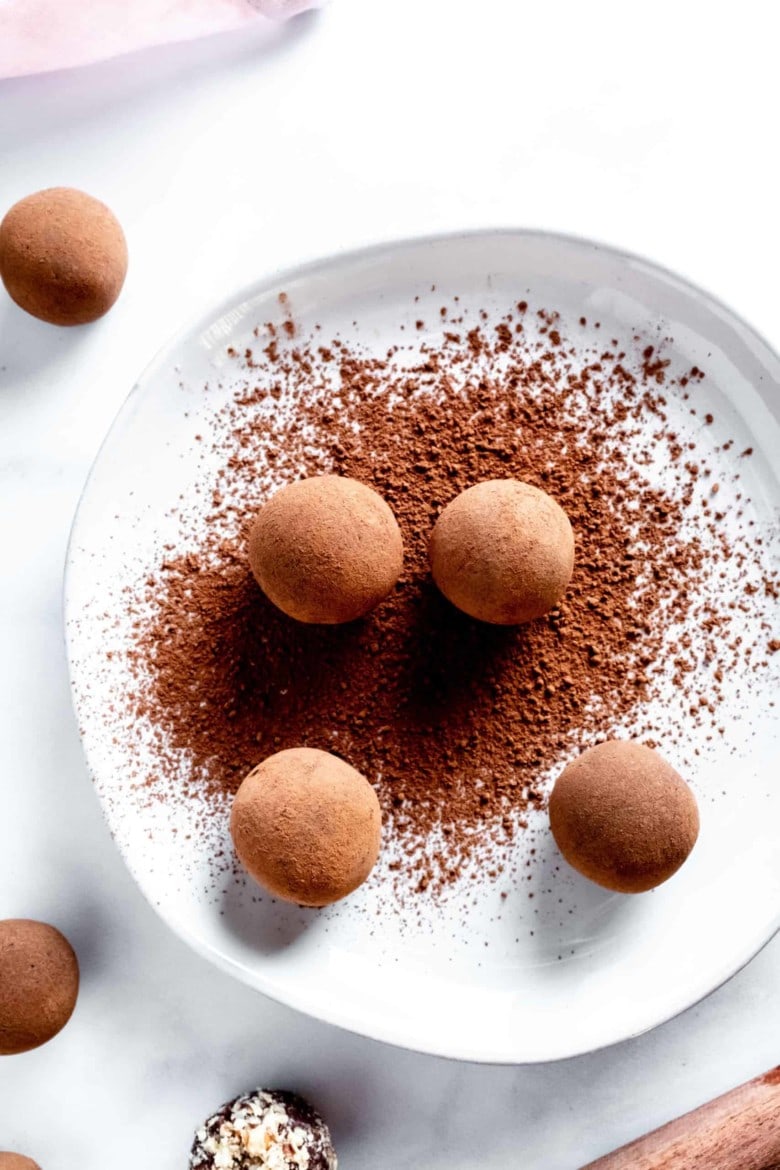 chocolate truffles on a plate with cocoa powder