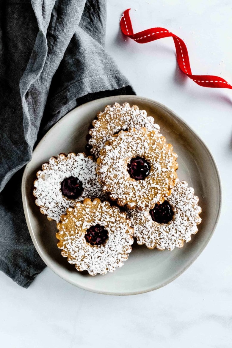 linzerkekse with raspberry jam on a plate