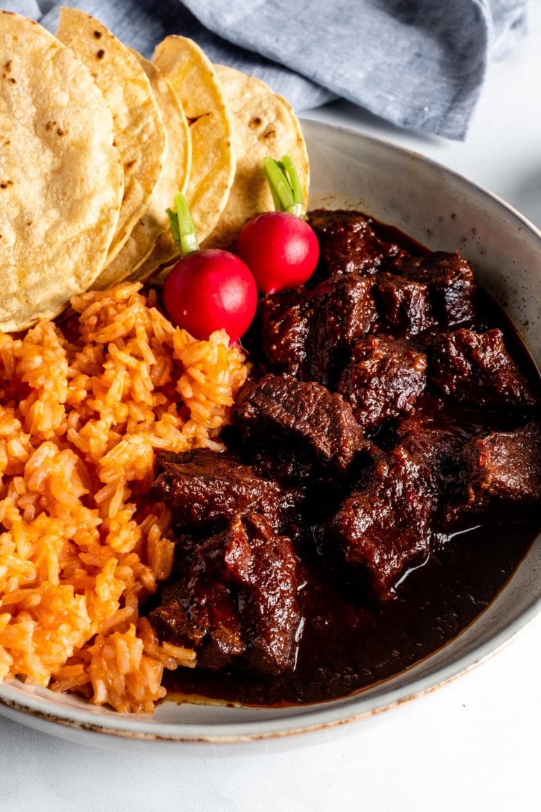 plate of chili with rice and tortillas