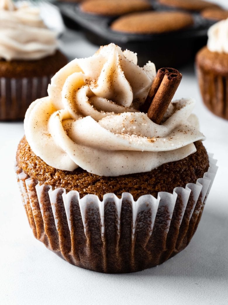frosted gingerbread cupcake with cinnamon stick garnish