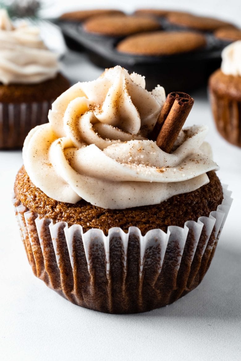 frosted gingerbread cupcake with cinnamon stick garnish