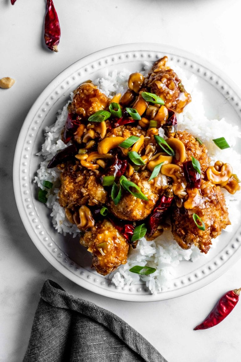 plate of rice with kung pao cauliflower, green onions and cashews