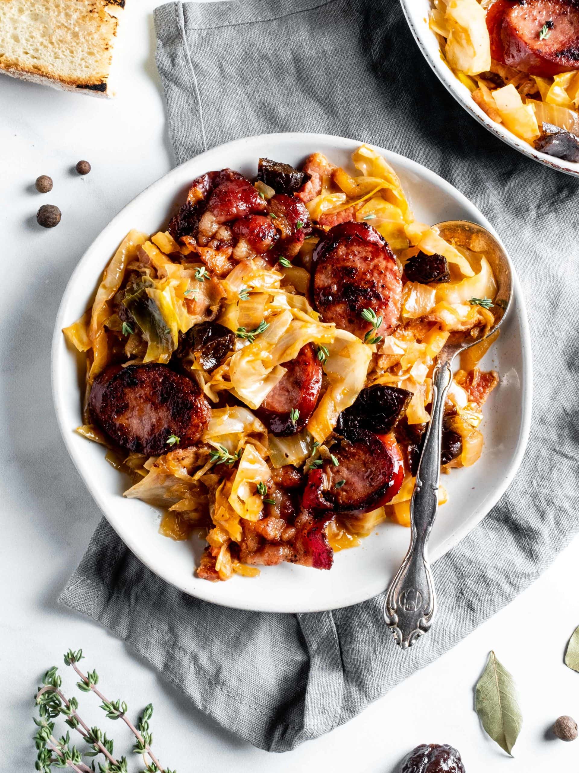 plate of bigos with kielbasa and bacon