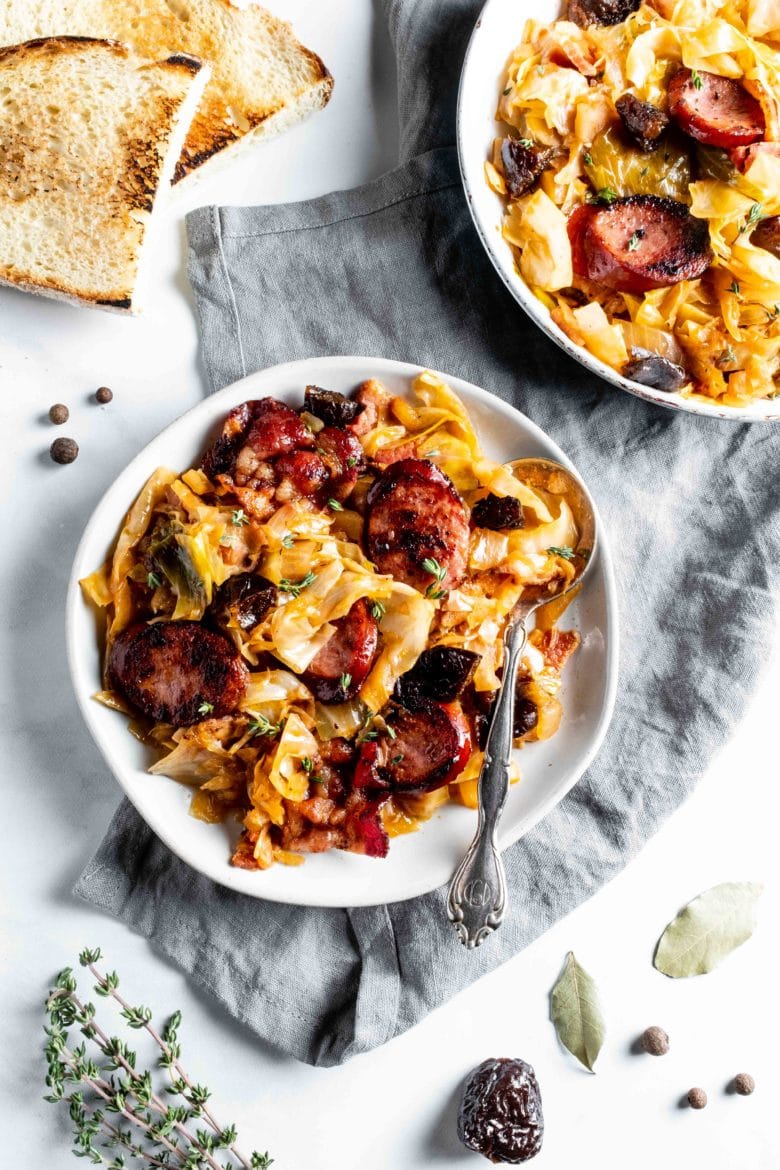 plate of bigos with kielbasa and bacon