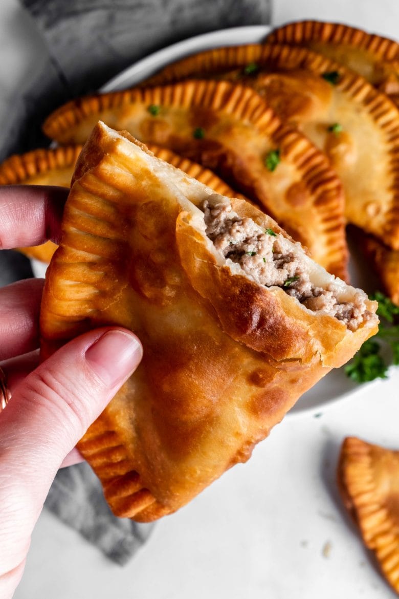 half of a chebureki with ground beef filling