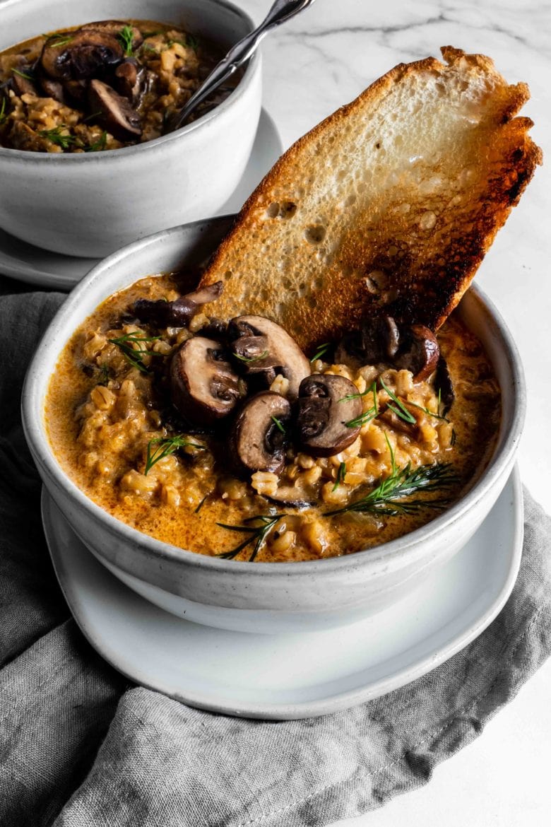 bowl of barley soup with mushrooms and toast