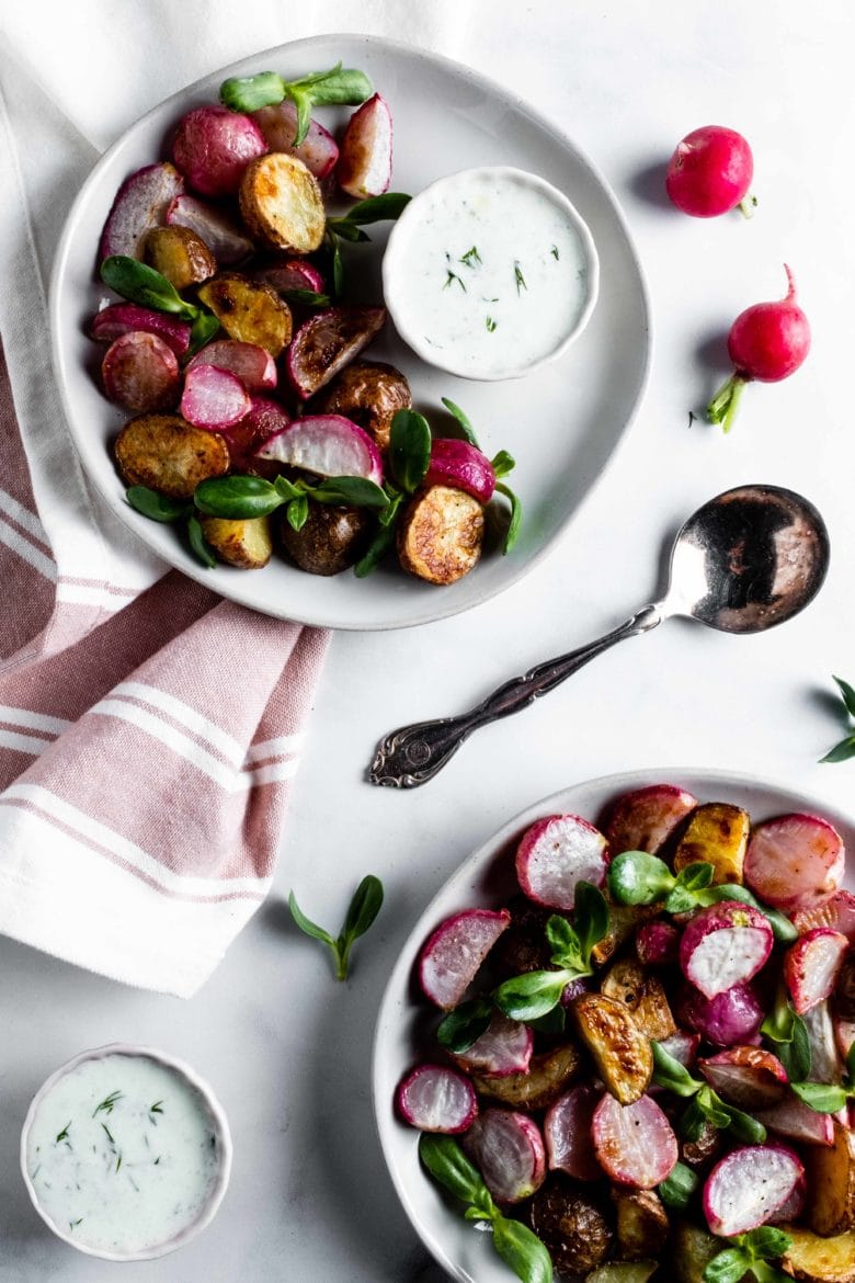 two plates of roasted radishes and potatoes