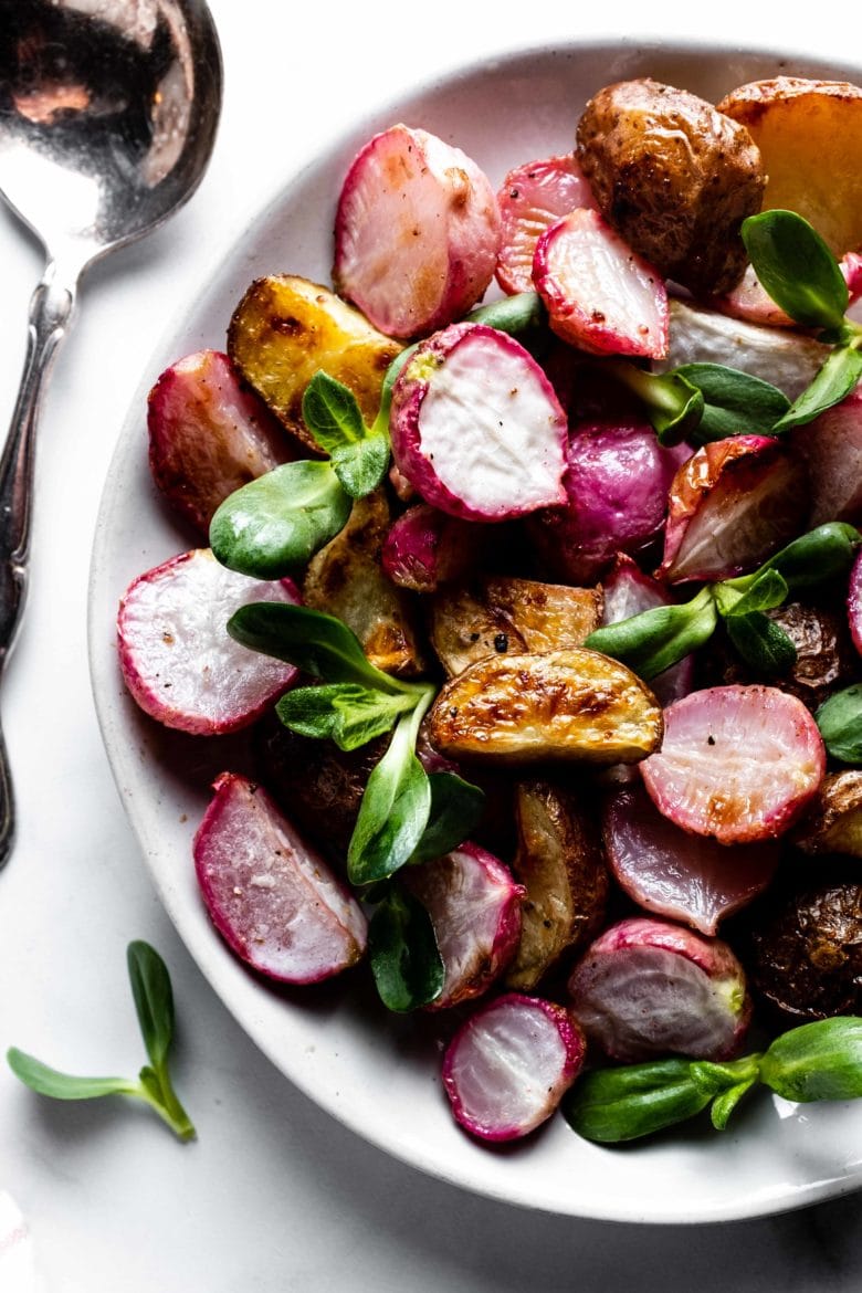 close up of roasted radishes, potatoes and sprouts