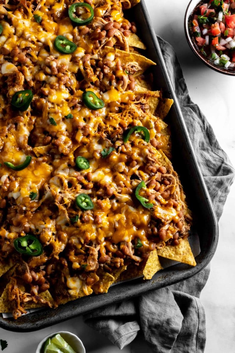 pulled pork nachos topped with jalapenos