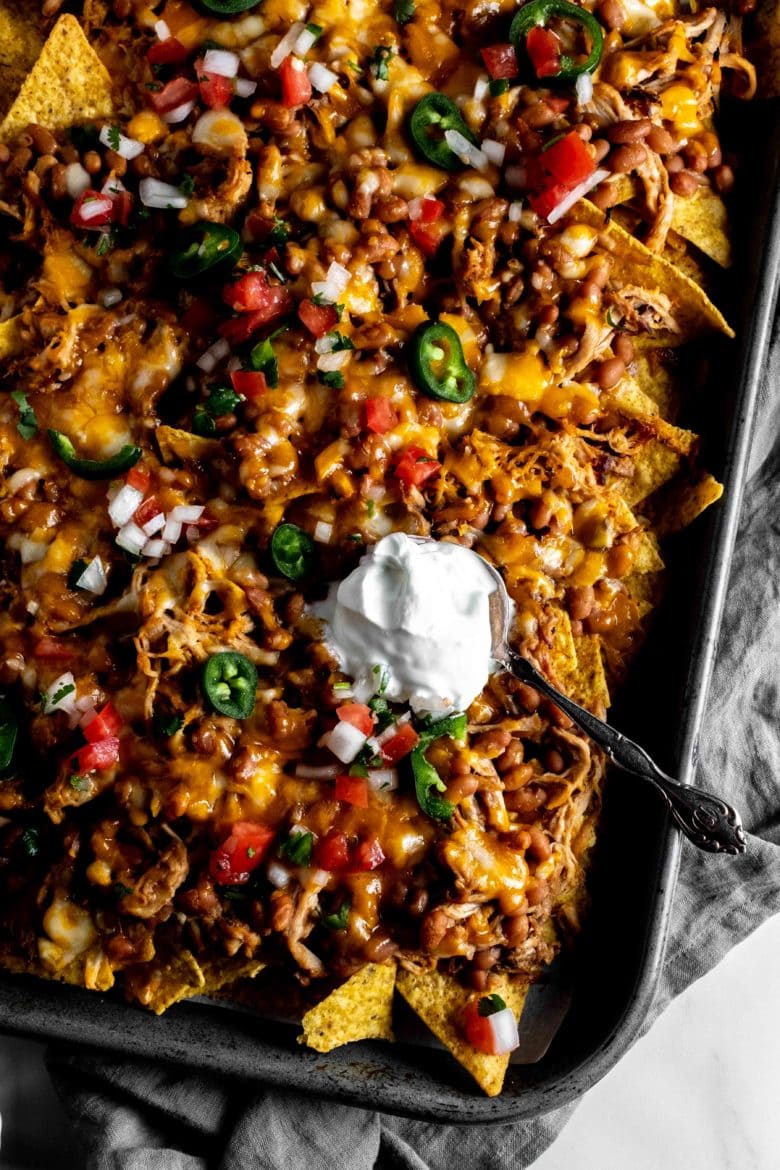 sheet pan nachos with pulled pork, baked beans and cheese