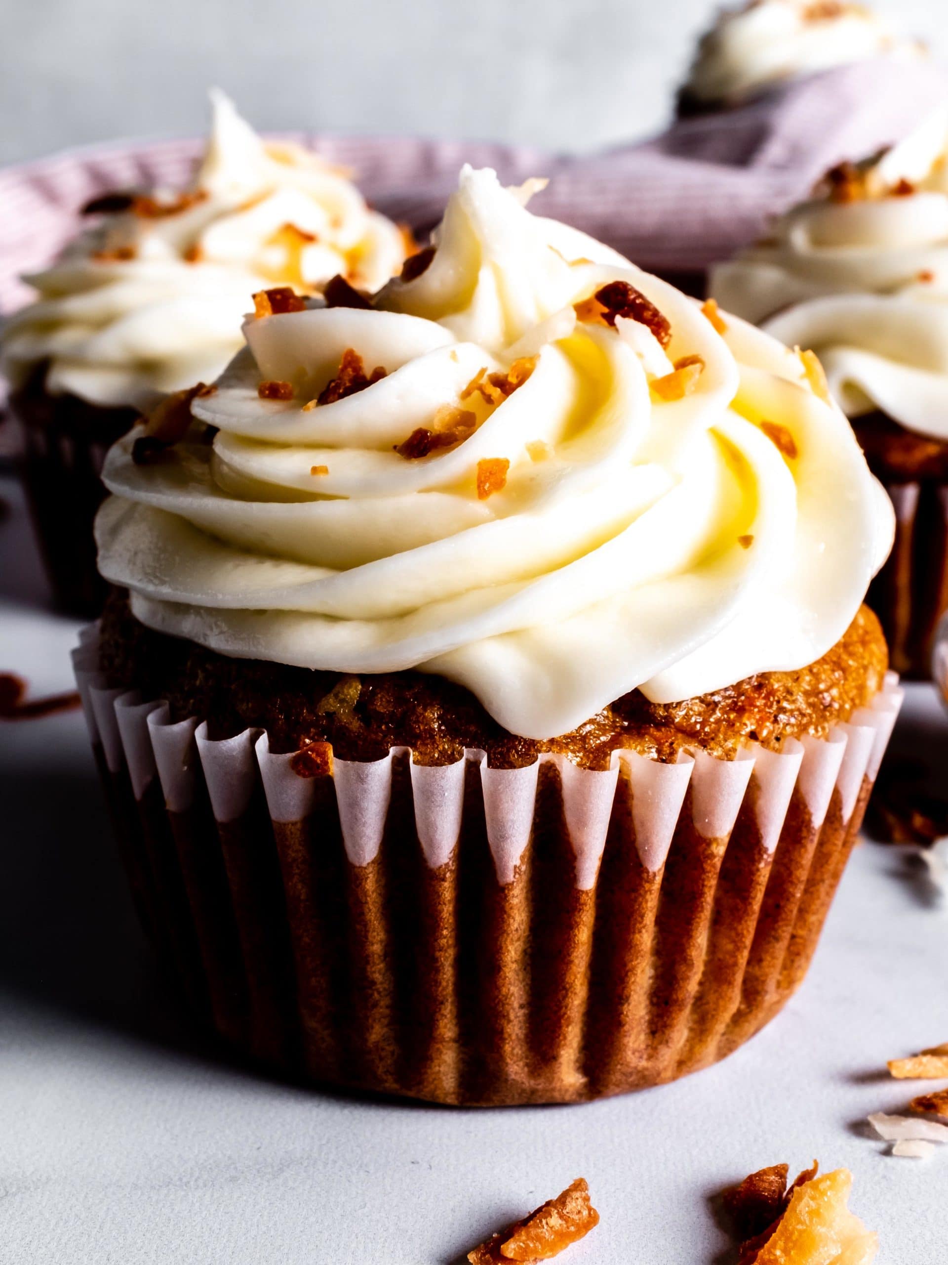 close up of carrot cake cupcake with cream cheese frosting