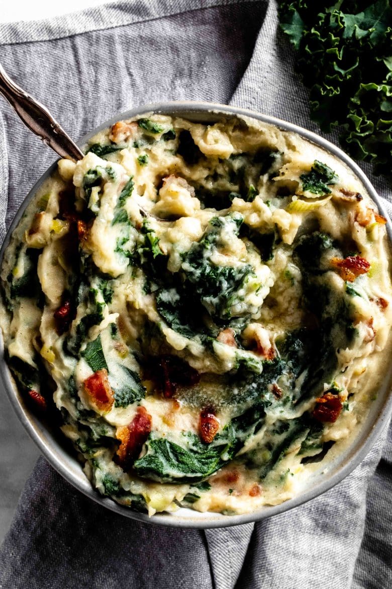 bowl of mashed potatoes with kale and bacon