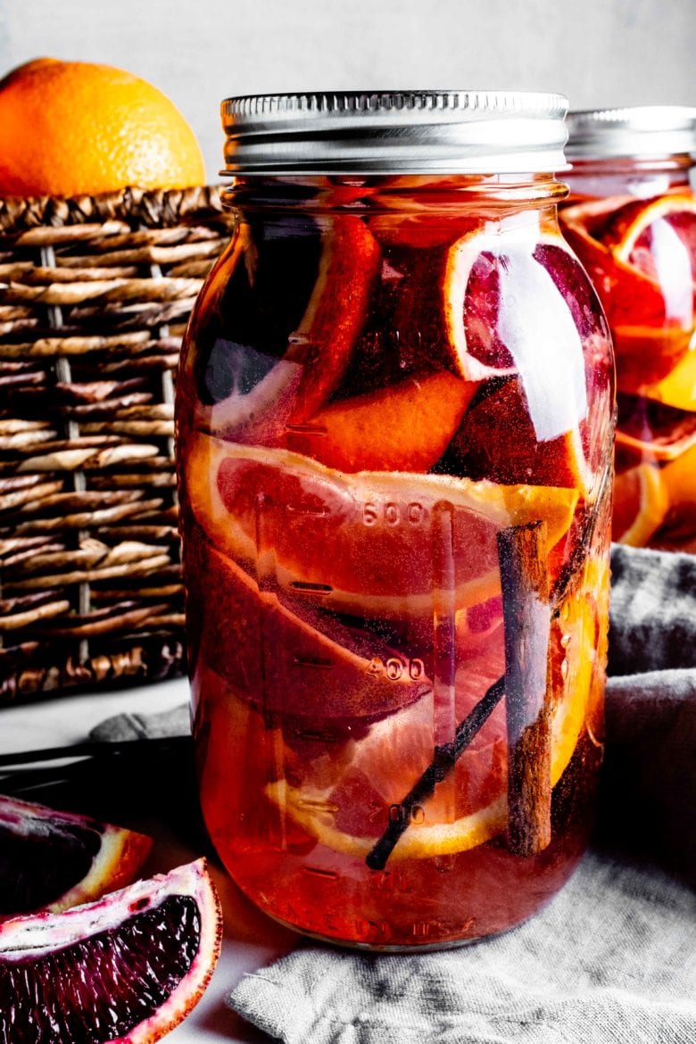 jar with orange slices, cinnamon and vanilla bean