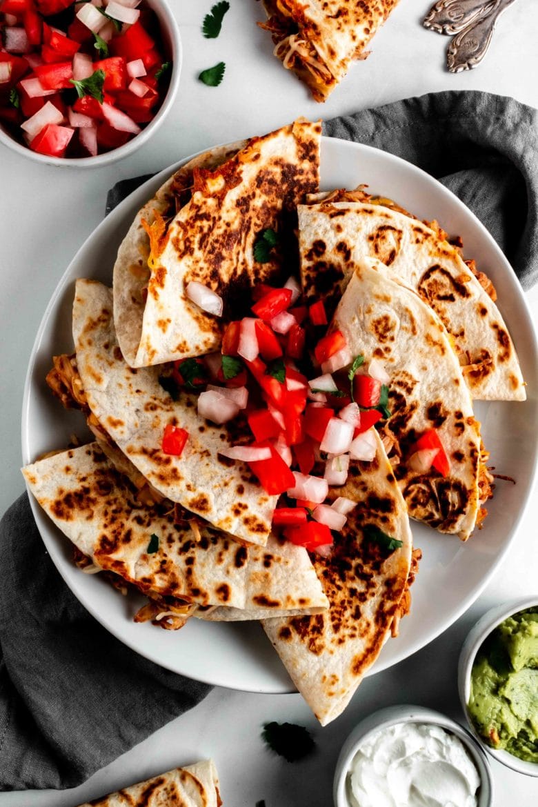 plate of jackfruit quesadillas topped with pico de gallo