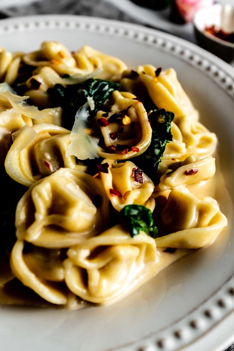 close up of tortellini in white wine cream sauce