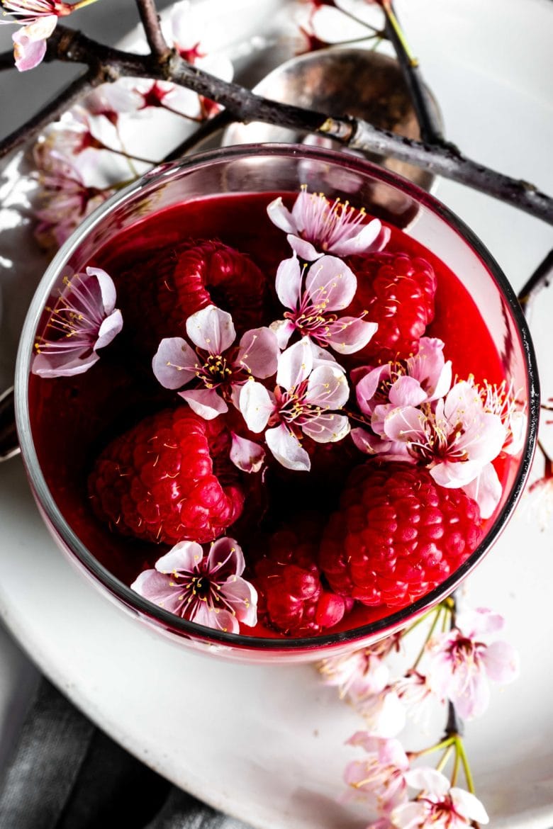 raspberry coulis topped with raspberries and flowers