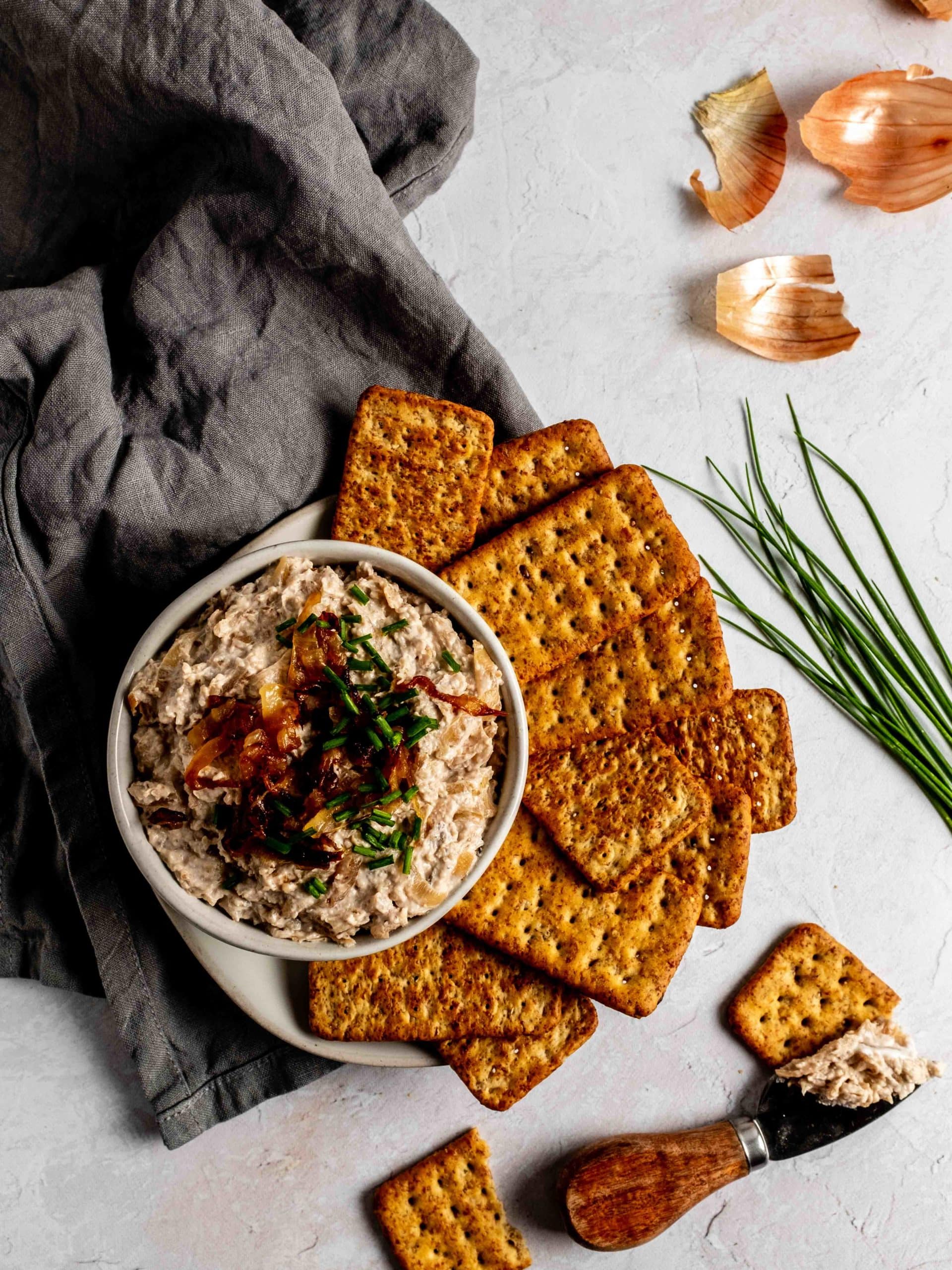 bowl of caramelized onion dip with crackers