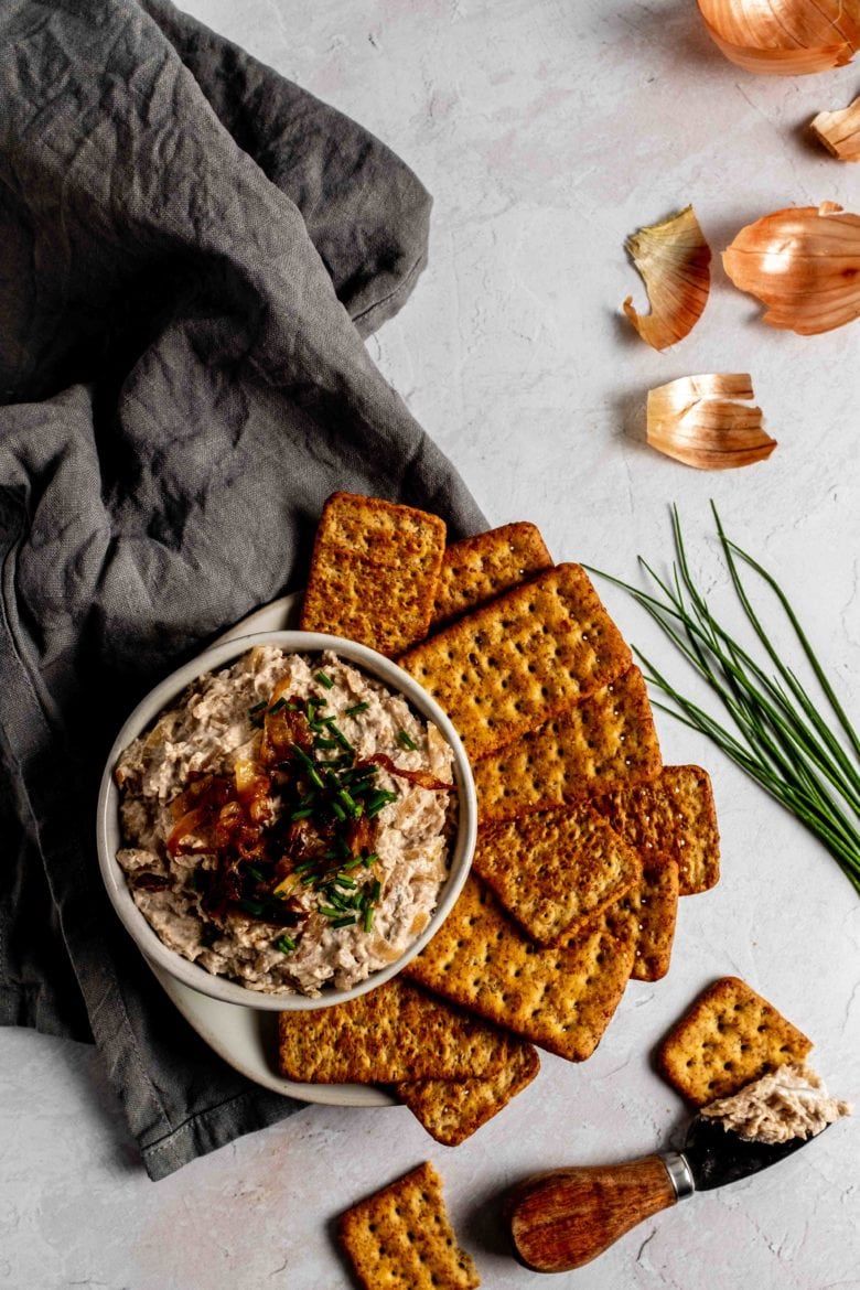 bowl of caramelized onion dip with crackers