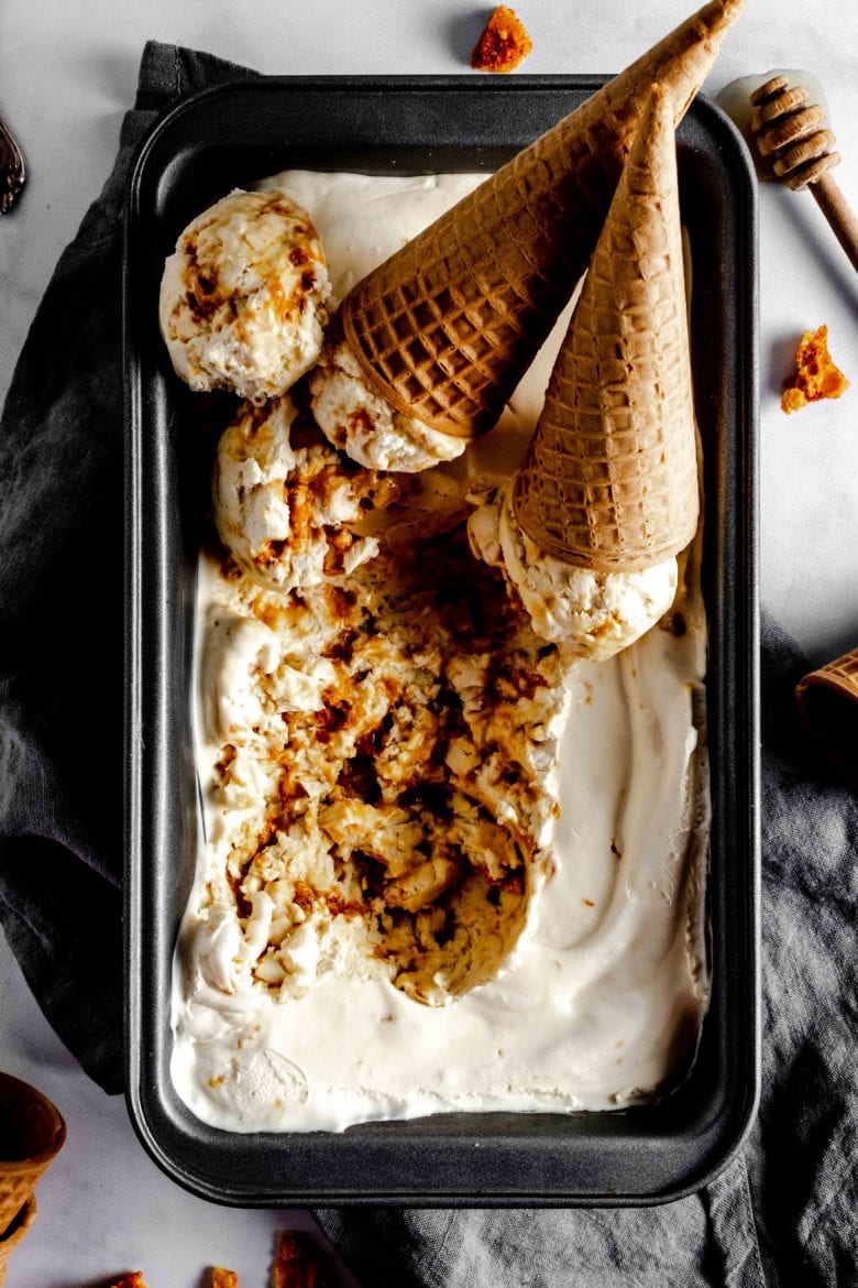 tin of honeycomb ice cream with two cones