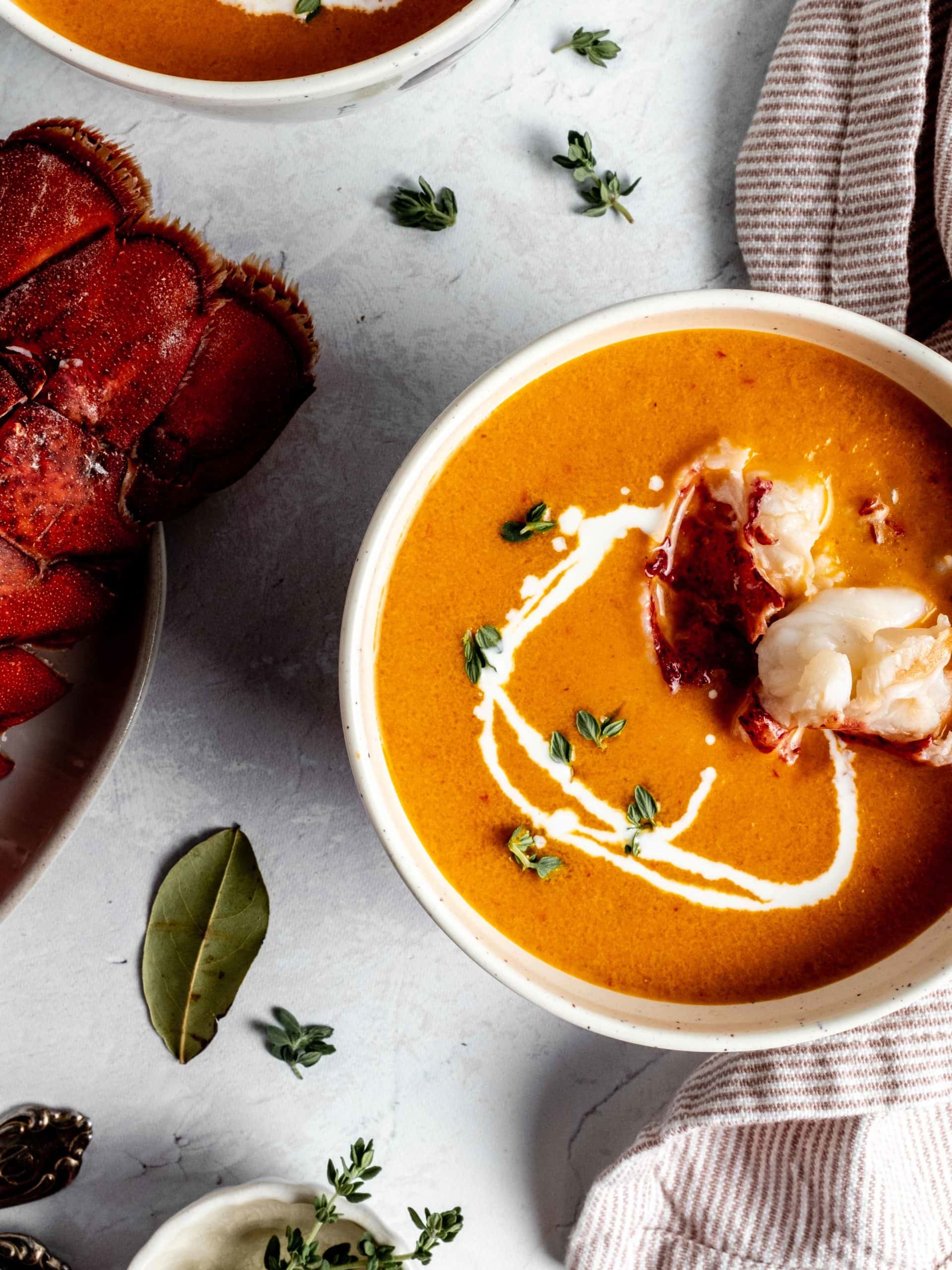 bowl of lobster bisque with pieces of lobster meat