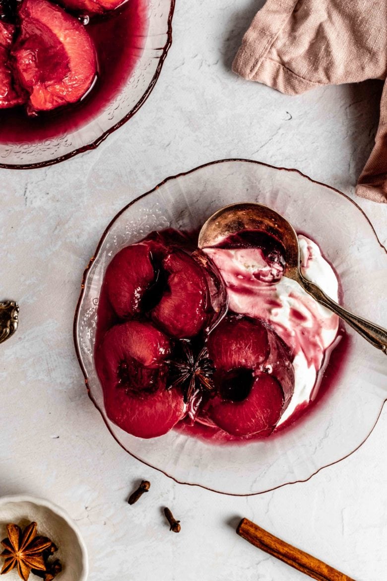 roasted plums on a plate with mascarpone cream