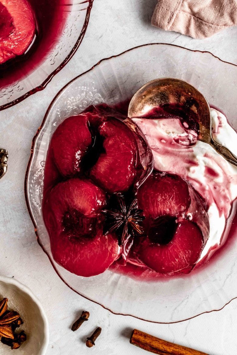roasted plums on a plate with mascarpone cream