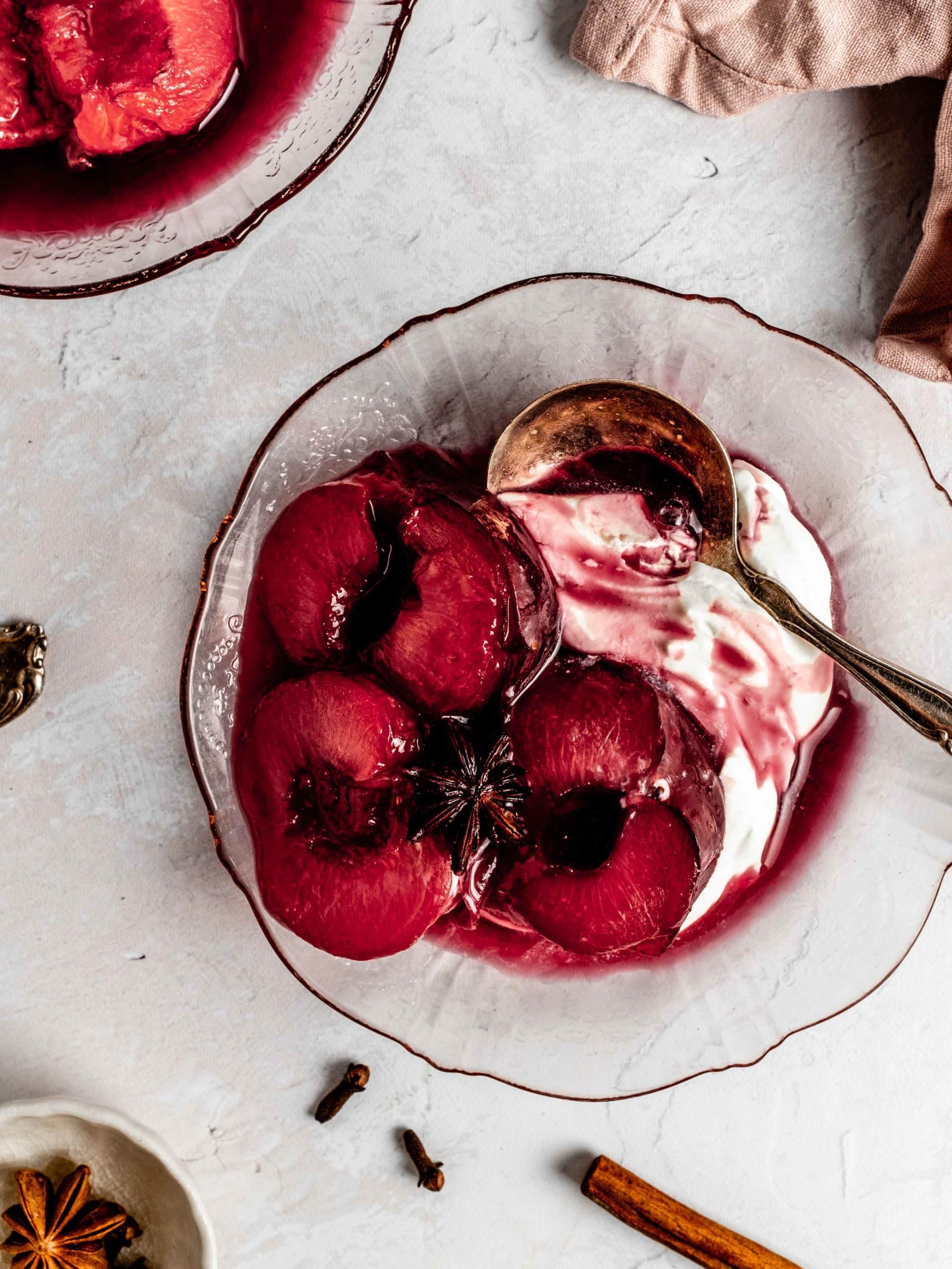 roasted plums on a plate with mascarpone cream