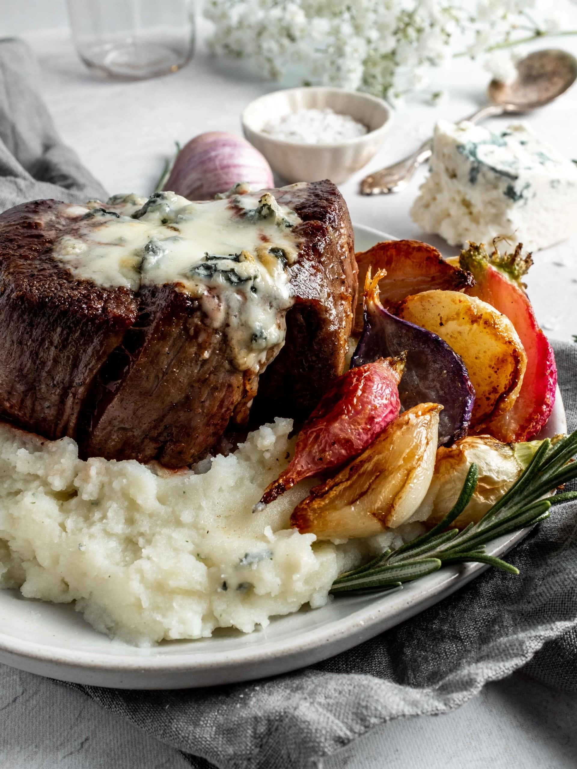 filet mignon covered in gorgonzola with roasted radishes