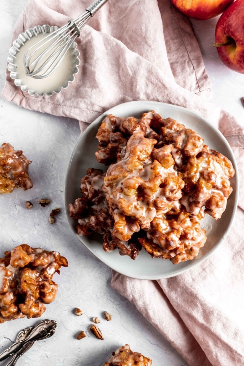 apple fritters on plate with maple glaze