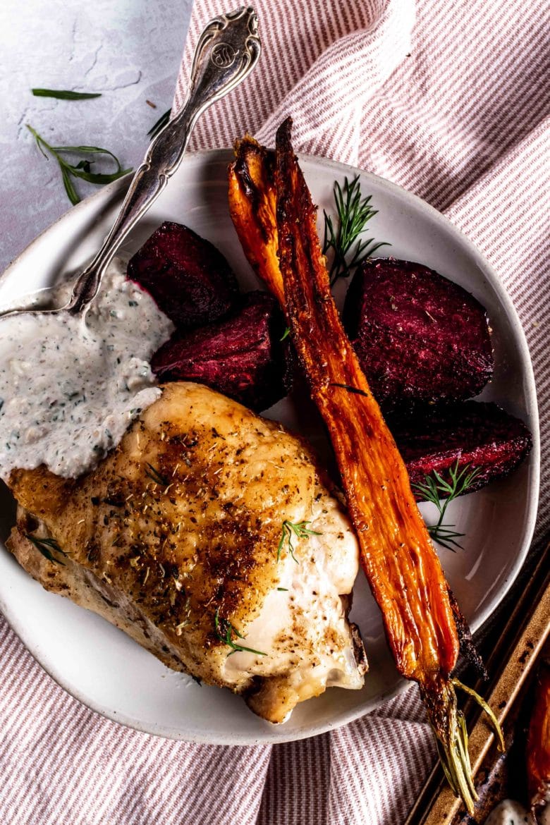 plate with chicken, carrots, beets and yogurt sauce