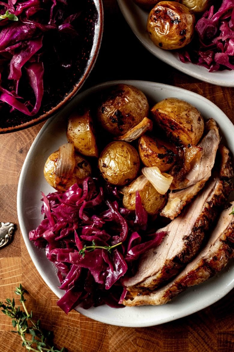 plate with duck, potatoes and braised red cabbage