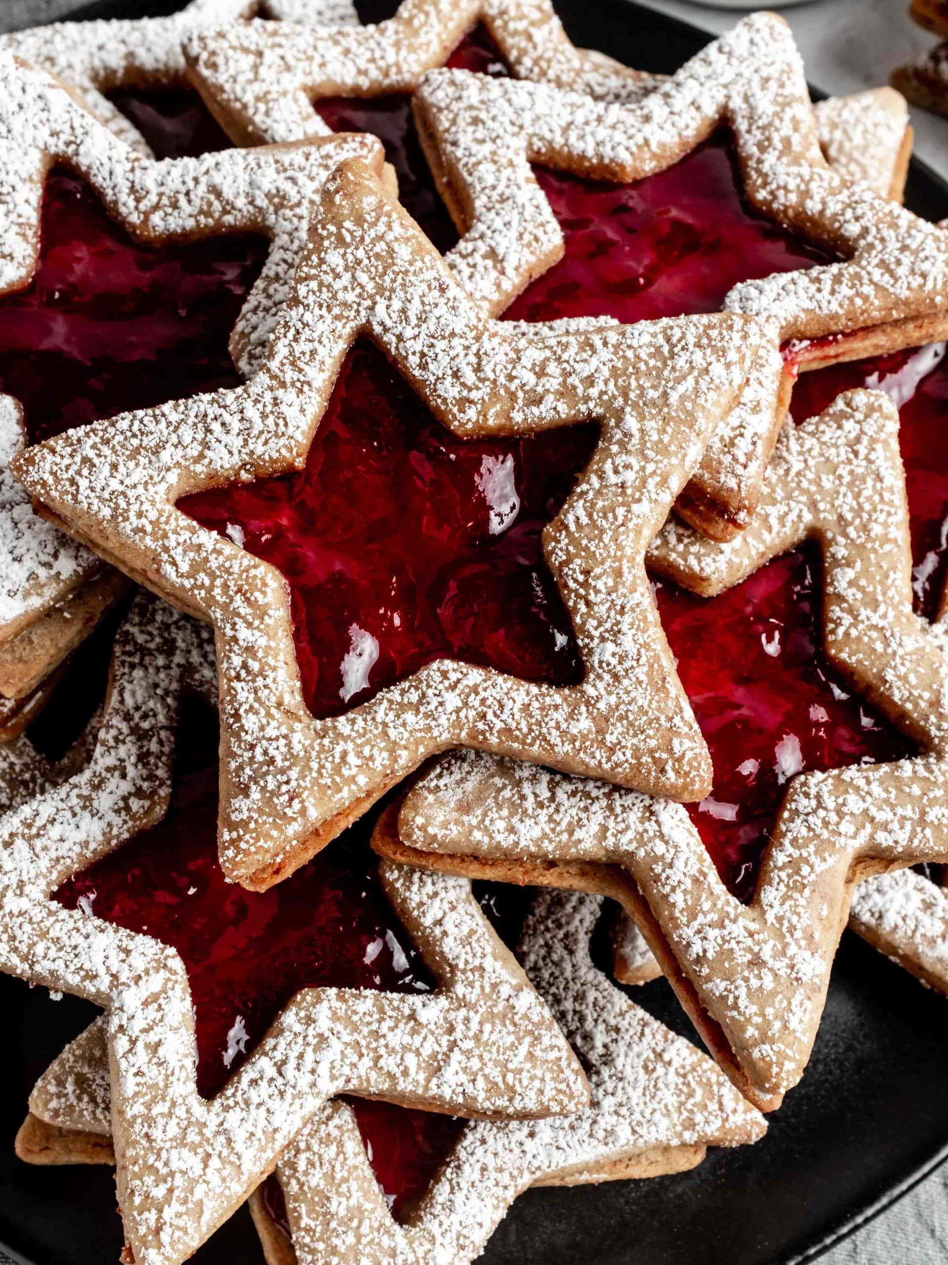linzer cookies dusted with powdered sugar on a plate