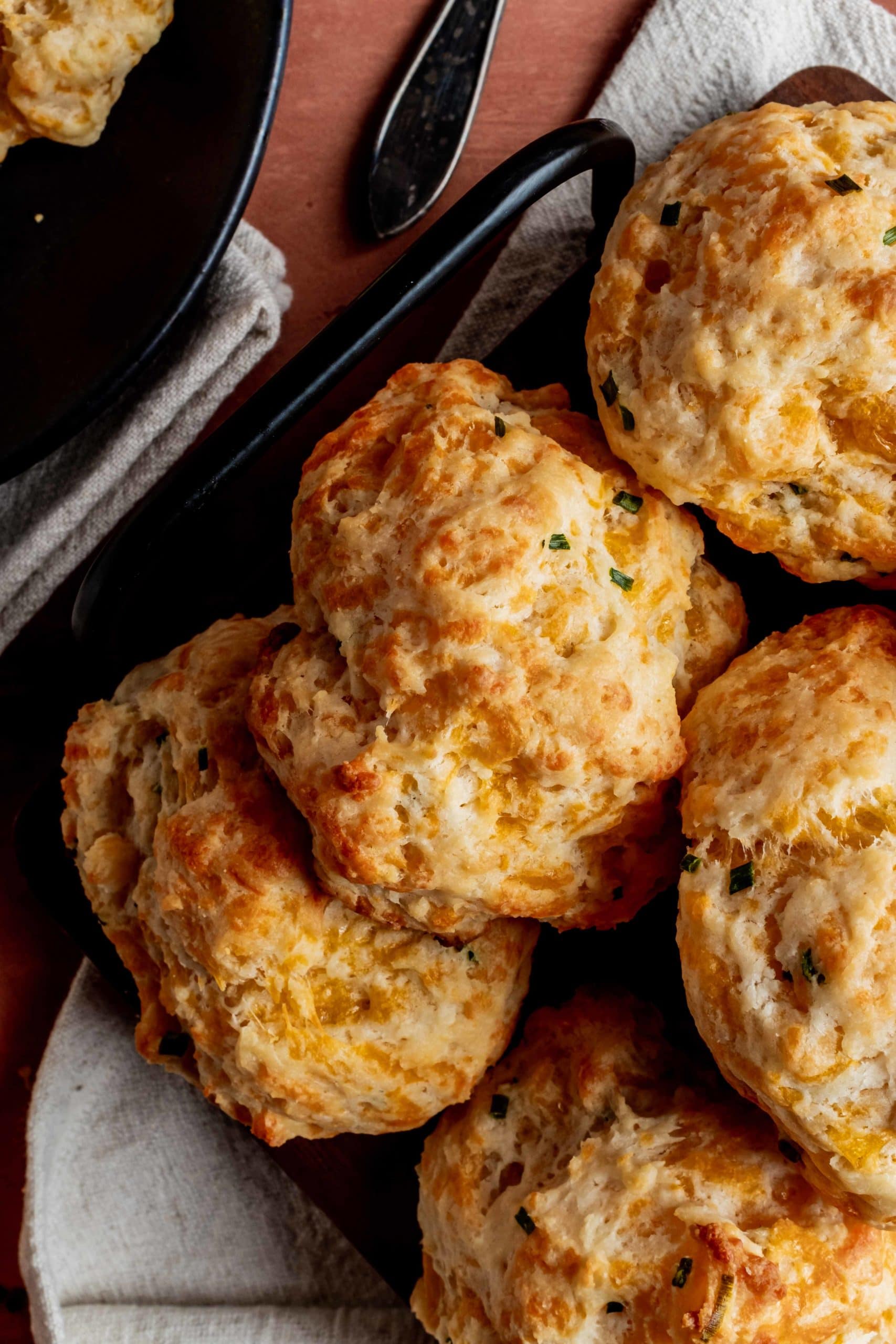 close up of golden brown cheddar chive biscuits