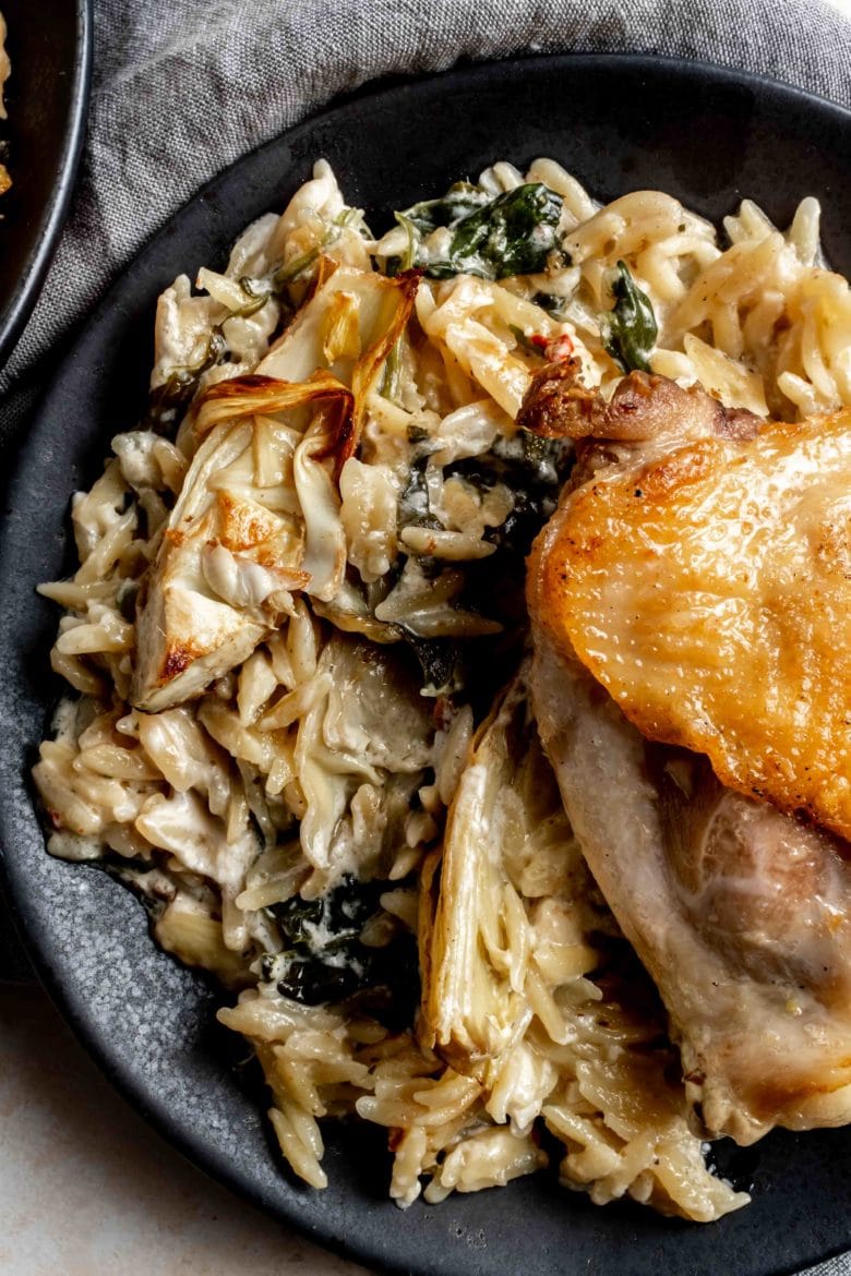 close up of orzo with artichokes and spinach