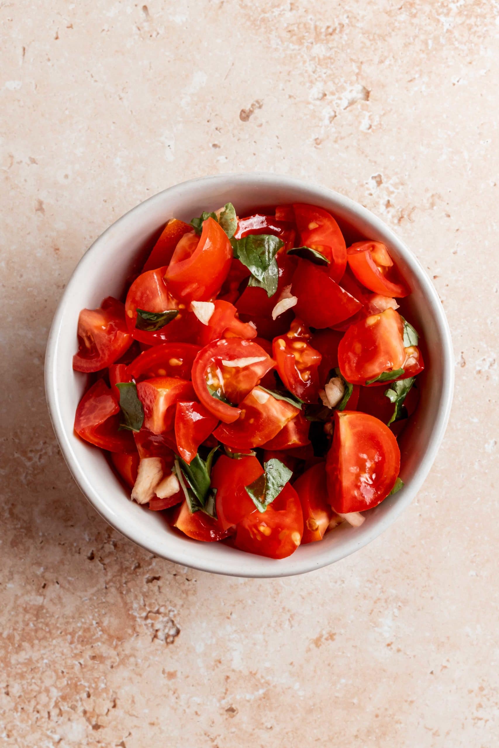 bowl with chopped tomatoes, basil and garlic
