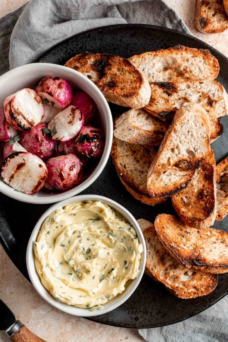 platter with grilled radishes, toasted baguette and herb butter