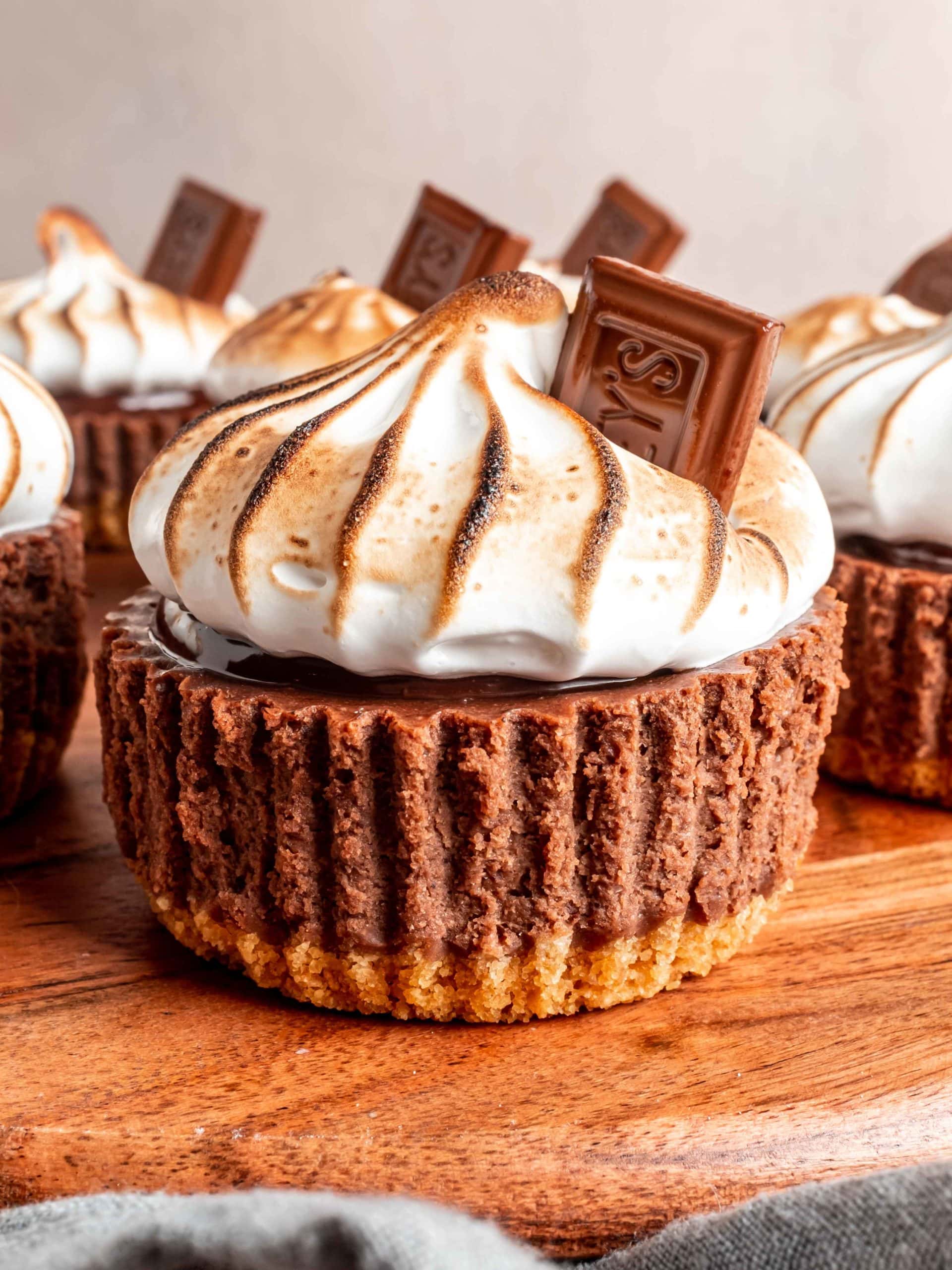 cheesecake garnished with toasted meringue and hershey bar