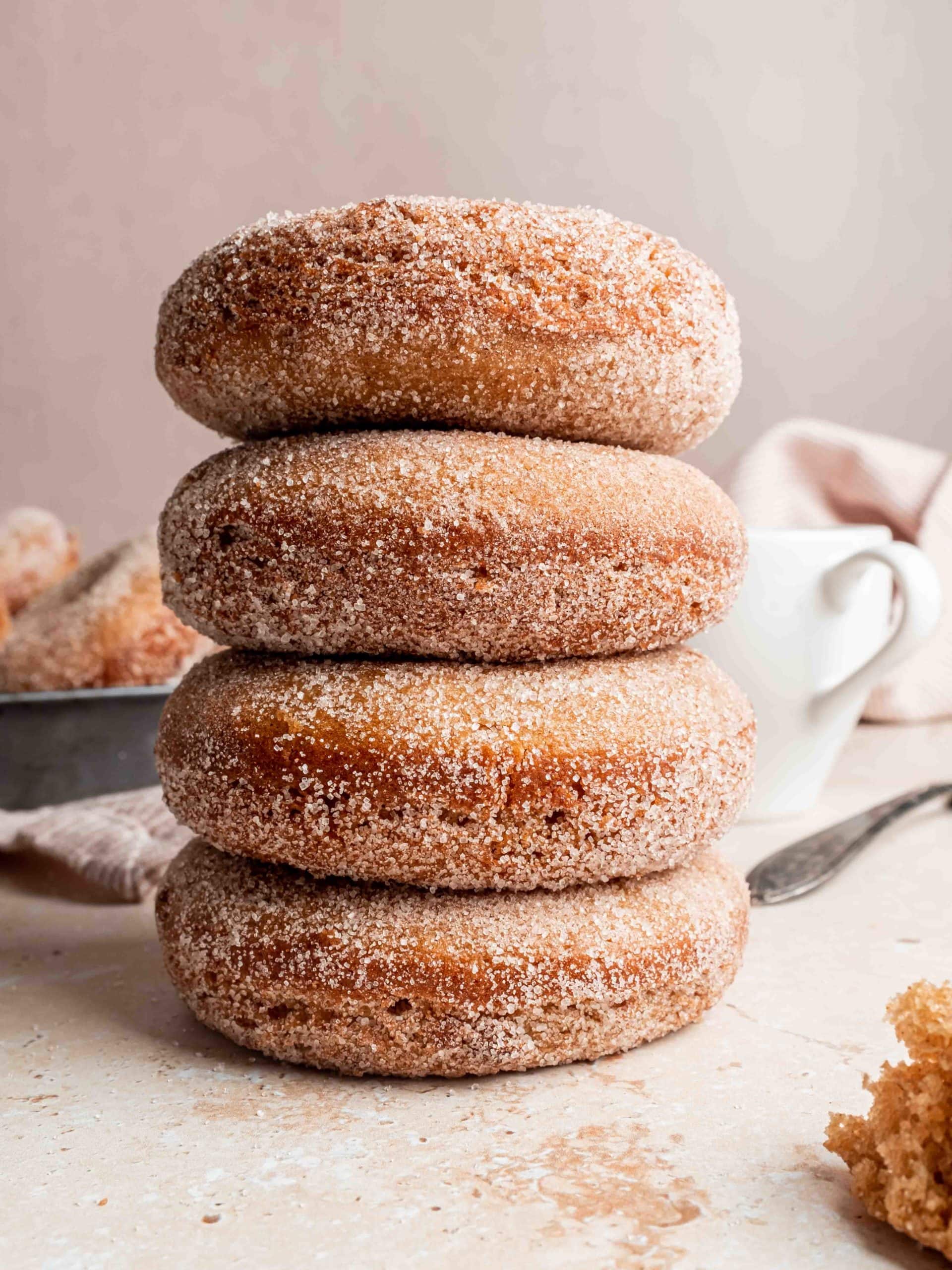 stack of cider donuts coated in cinnamon sugar