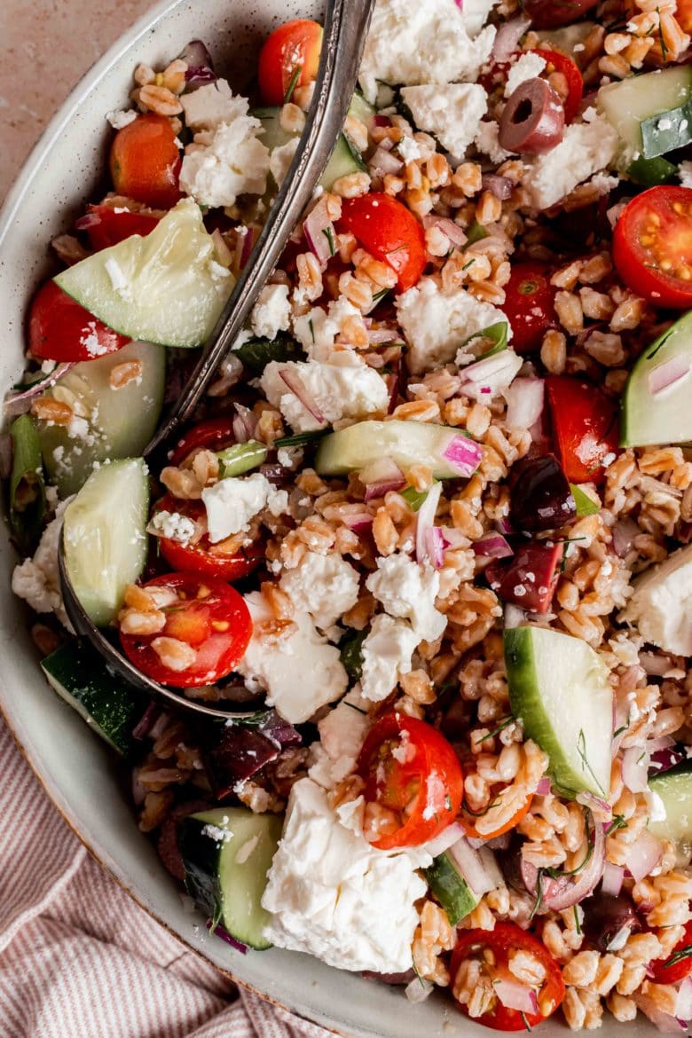 spoon in bowl of greek farro salad