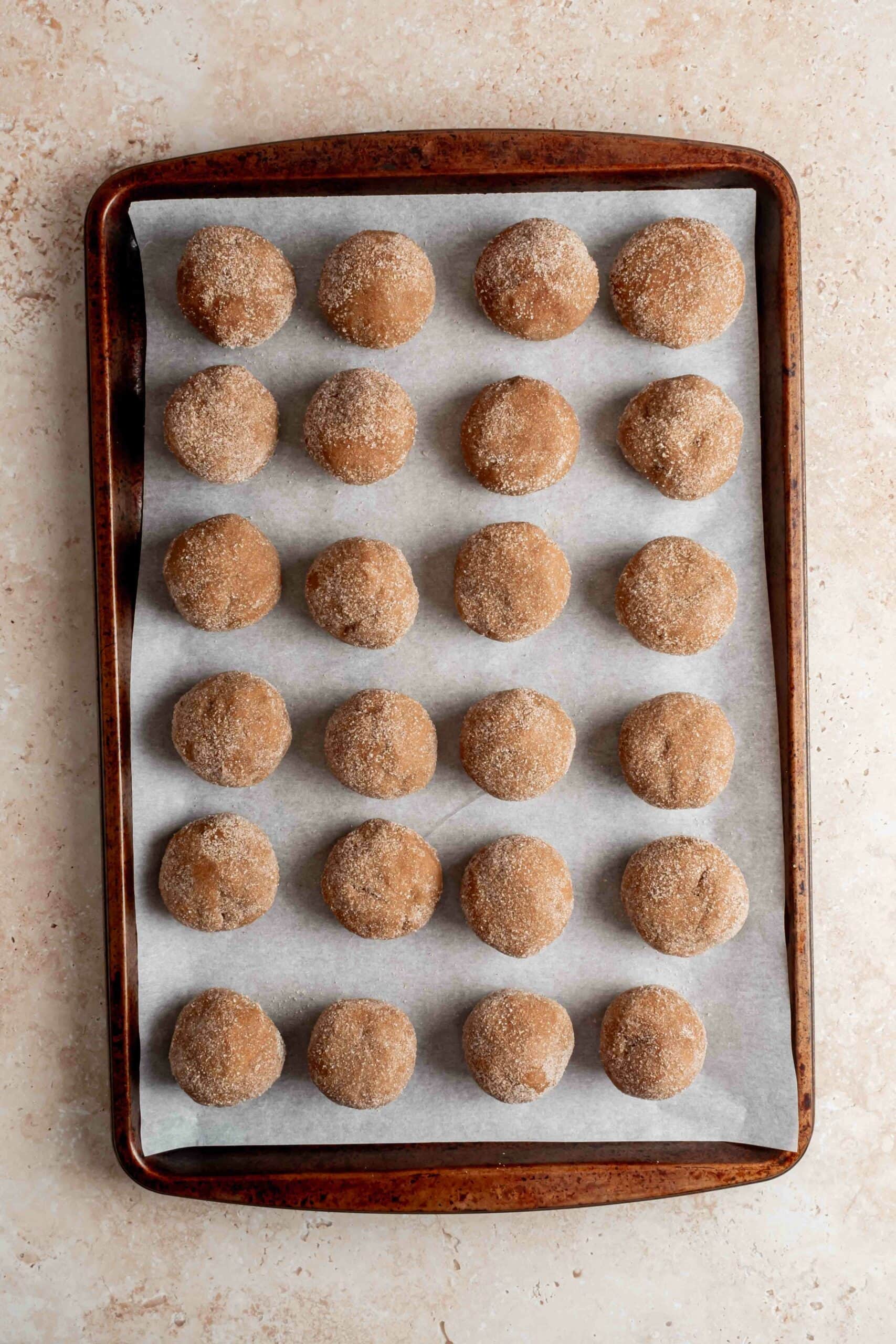 cookie dough balls rolled in cinnamon sugar and ready to bake