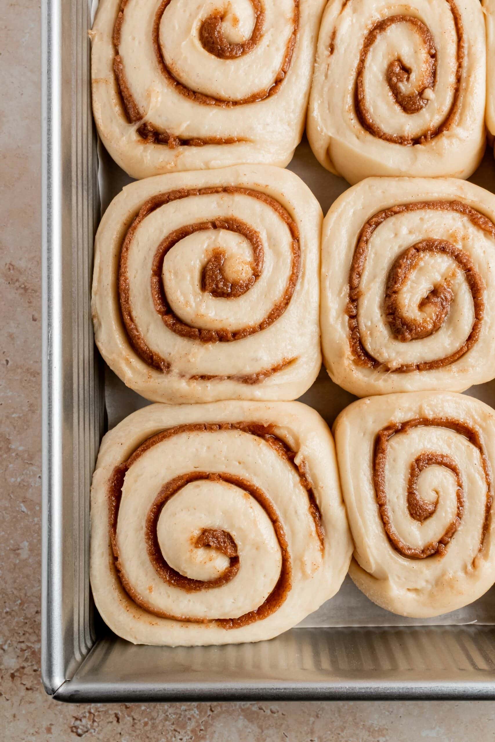 close up of unbaked cinnamon rolls after final proof