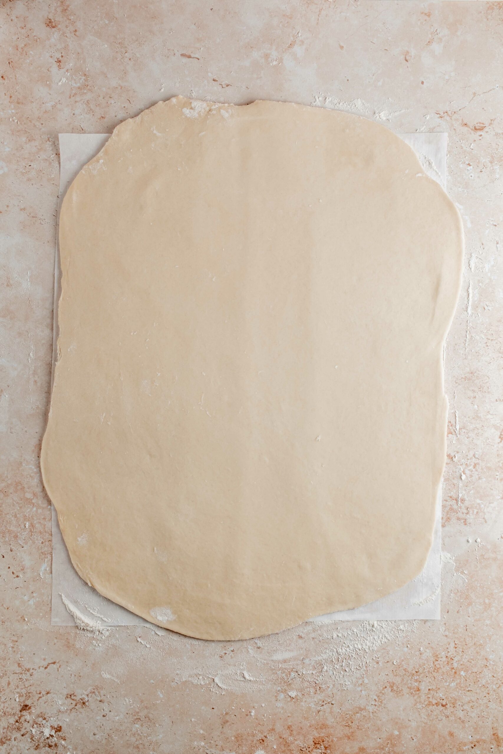 dough rolled out into thin layer