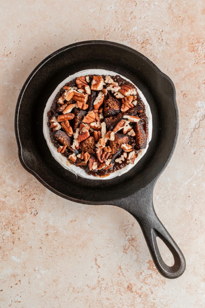 brie in cast iron skillet before baking