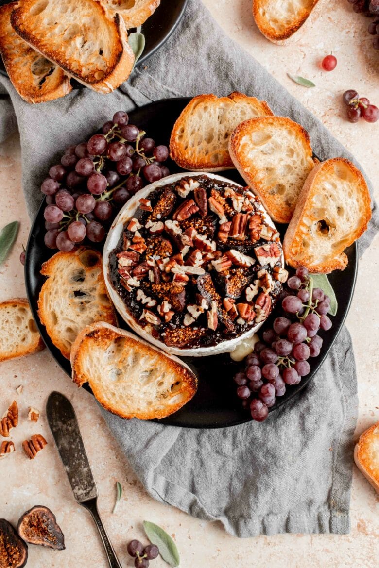 platter with brie, crostini and grapes