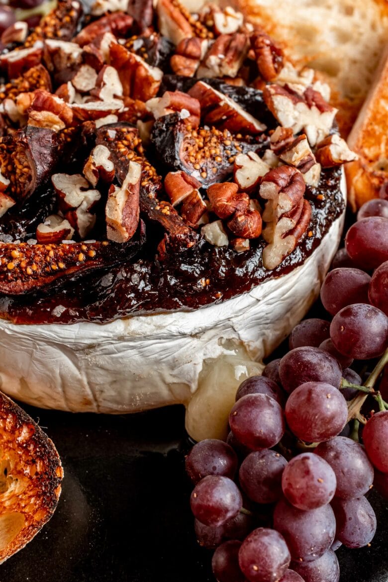 close up of brie topping: fig jam, dried figs and pecans