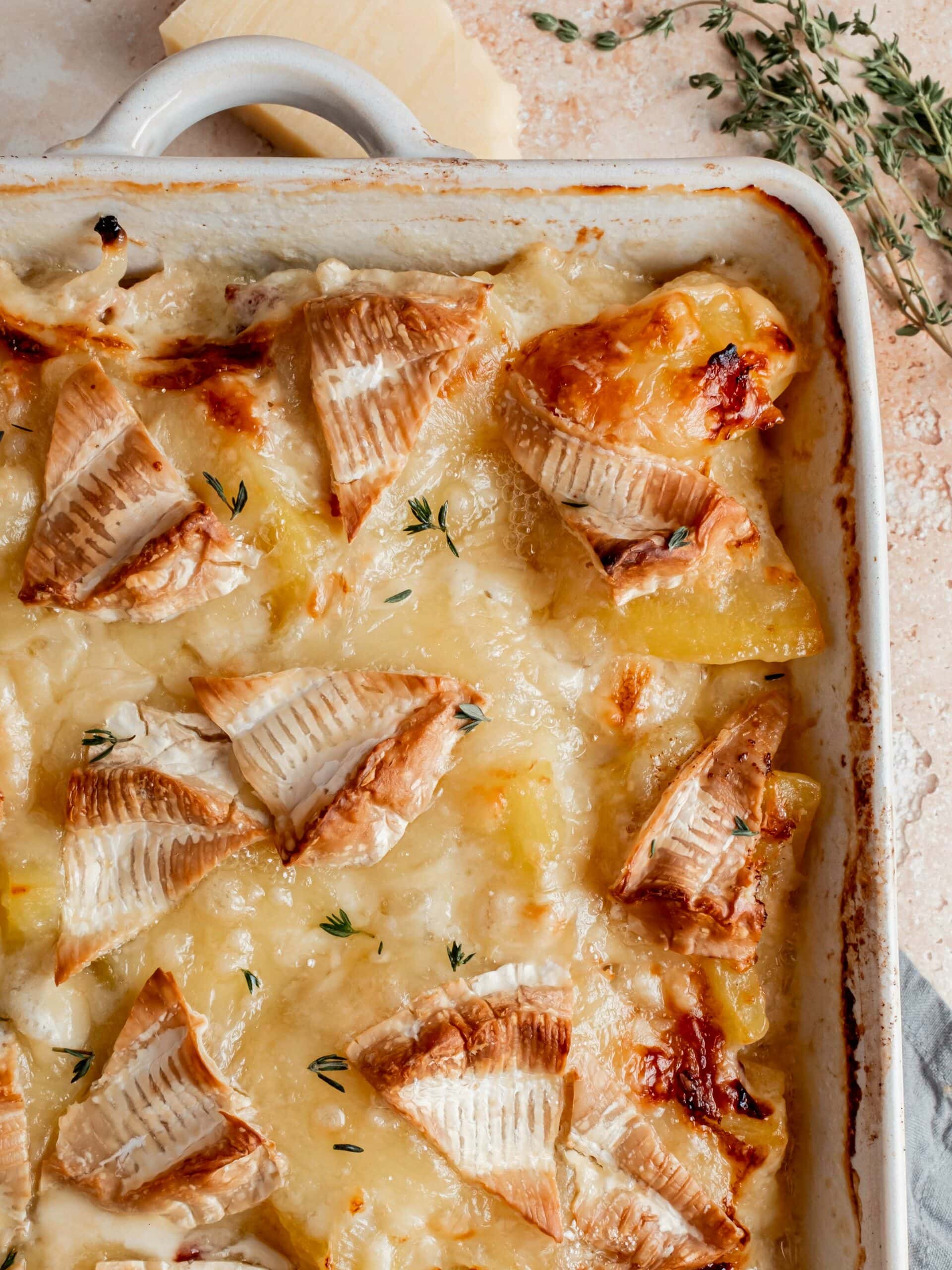 close up of baked scalloped potatoes in baking dish