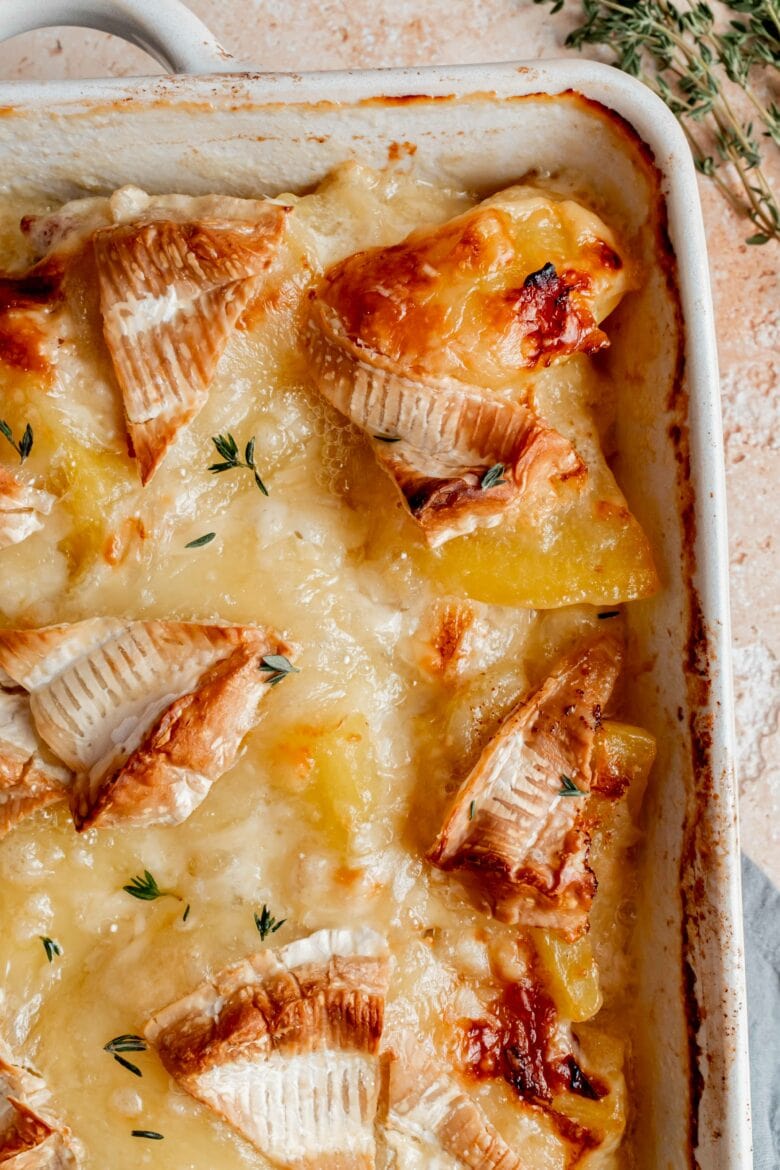 close up of baked scalloped potatoes in baking dish